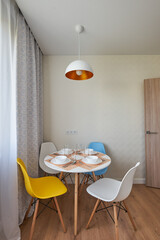Served white round table in Scandinavian style.