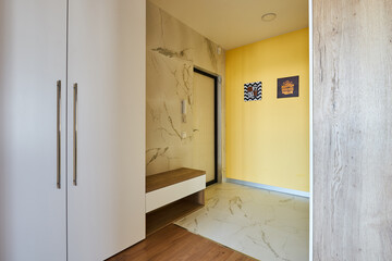 a minimalistic hallway with a large wardrobe with a mirror