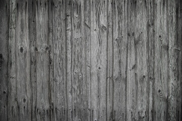 Fototapeta na wymiar fragment of a fence made of old wooden boards with remnants of paint and nails, natural texture, background