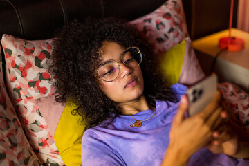 Overhead shot of young adult female looking at a smartphone
