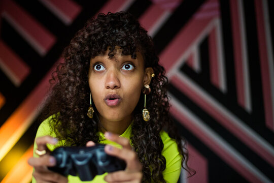 Female Gen Z gamer using a video game console