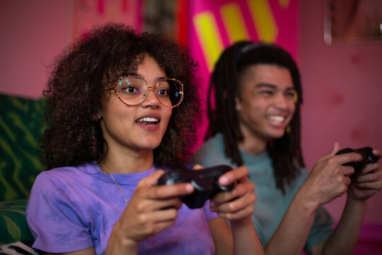 Gen Z friends playing a video game with console