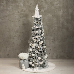 Isolated gray-white long Christmas tree with plush tigers on concrete background 