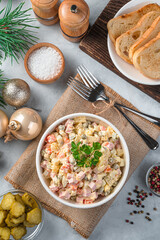 Olivier salad on a Christmas background. Traditional festive Russian salad. Vertical view.