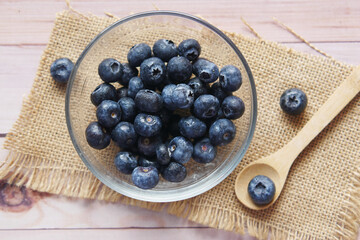 Close up of fresh blue berry with water drops .