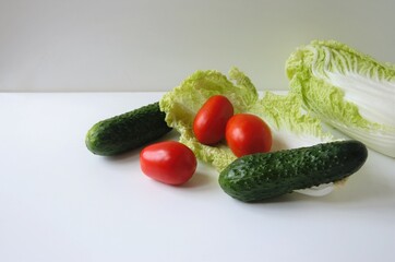ingredients of vegetable salad on a white background, minimalism
