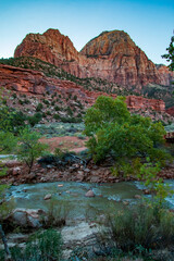 morning sunlight illuminating the canyons in Zion national park in Utah under a blue ,clear sky.