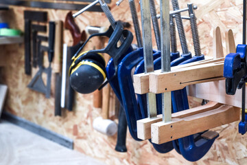 Work tools A selection of carpentry tools hang in a workshop for woodwork