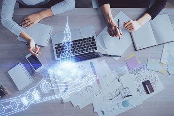Double exposure of woman hands working on computer and creative hologram drawing. Top View. Start up concept.