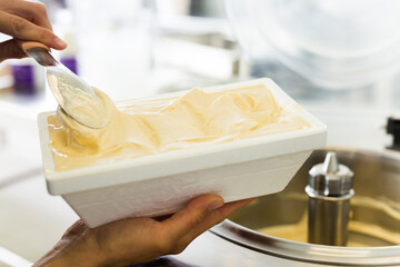Vanilla ice cream in thermal insulation packaging at factory