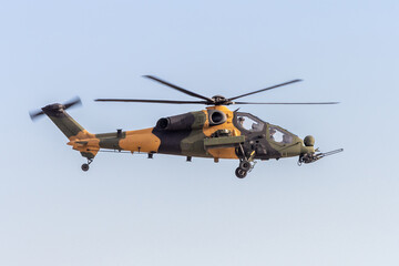 Military combat helicopter in flight - obrazy, fototapety, plakaty