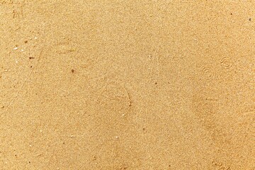 Fototapeta na wymiar Sand texture. Sandy beach for background. Top view. Natural sand stone texture background. sand on the beach as background. Wavy sand background for summer designs