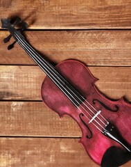 Fototapeta na wymiar violin on brown wooden background