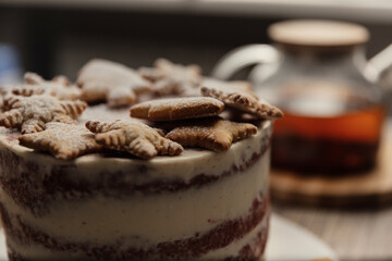 Chef or baker decorating cake with white whipped cream.Soft fokus