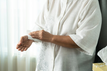 Senior woman cleaning her hands with white soft tissue paper. isolated on a white backgrounds