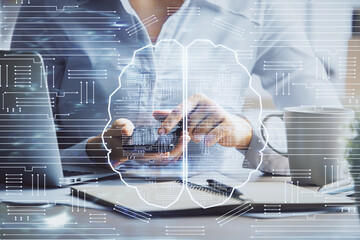Double exposure of brain sketch hologram and woman holding and using a mobile device.