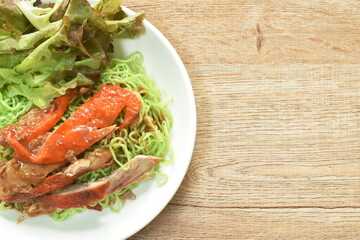 Chinese jade noodles topping slice rosted duck dressing sweet soy sauce on plate
