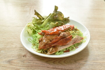 Chinese jade noodles topping slice rosted duck dressing sweet soy sauce on plate