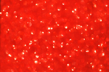 Defocused christmas red glitter background with bokeh. Holiday glowing backdrop,banner.