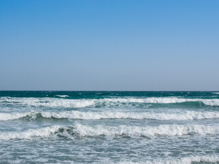 rough blue sea with waves with foam
