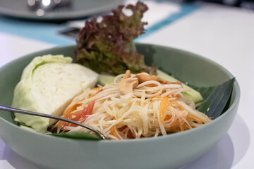 Papaya salad on the wooden table, Thai food.