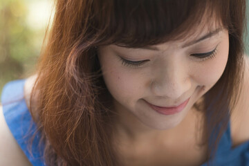 Fototapeta premium Close up of young pretty Asian woman in the garden.