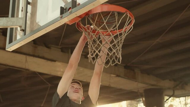 Basketball player scores a dunk on a basketball hoop