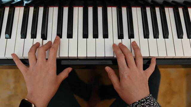 Hand female practicing with playing the piano instrumental