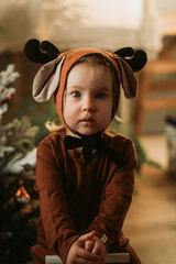 Portrait of Toddler baby girl in rudolph reindeer costume. Christmas concept