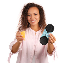 Young African American woman with reusable pad and menstrual cup on white background
