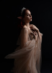 close up portrait of red haired  girl wearing a creamy fantasy gown like a fairy goddess costume. ...