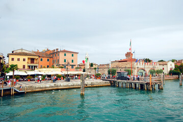 Fototapeta na wymiar Port promenade with ship jetty in Lazise lake Garda. Italy, Europe