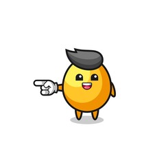 golden egg cartoon with pointing left gesture