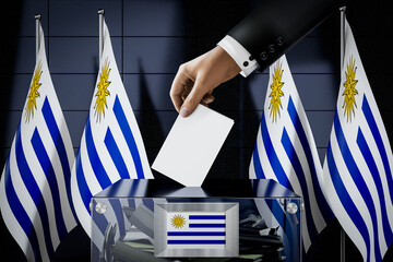 Uruguay flags, hand dropping ballot card into a box - voting, election concept - 3D illustration