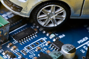 CPU chip and semiconductors with car toy. Global car chip shortage. Micro-chip shortage creates...