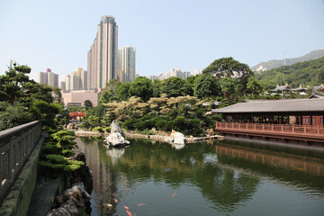 Traditional wooden tea house and pond with goldfish in Nan Lian garden in Hong Kong