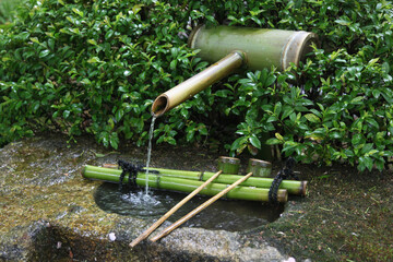 Traditional water spring with bamboo ladles in Japan. Temizu-ya is a Shinto water pavilion for a ceremonial purification rite known as temizu or chōzuya