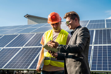 foreman and engineer  work during checking and repairing solar photovoltaic panel
