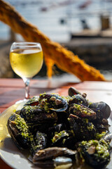 Dish with mussels and wine on the seashore in Montenegro
