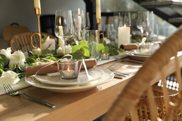 Elegant table setting with beautiful floral decor and burning candle