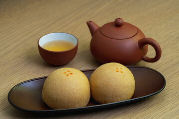 Closeup of mochi Japanese sweets in plate and red tea.