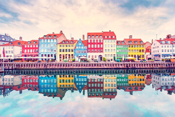 Breathtaking beautiful scenery with boats in the famous Nyhavn in Copenhagen, Denmark at sunrise. Exotic amazing places. Popular tourist atraction.