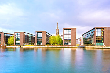 Fototapeta premium Breathtaking view with modern buildings and church spire on Copenhagen waterfront, Denmark. Exotic amazing places. Popular tourist atraction.