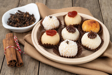 Typical gourmet brazilian brigadeiros, various flavors over wooden table