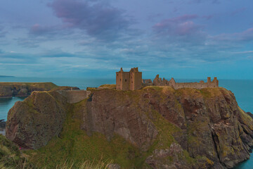 Dunnottar Castle is a ruined medieval fortress located upon a rocky headland on the north-eastern coast of Scotland south of Stonehaven.  Sunset Evening