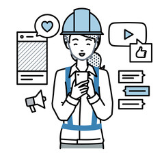 立ってスマートフォンでさまざまなSNSで楽しく交流する工事現場の女性