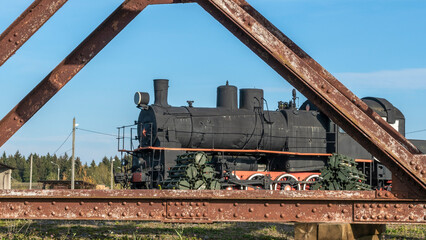 Retro Soviet steam locomotive. Veteran railways. Vintage black steam locomotive train rush railway.