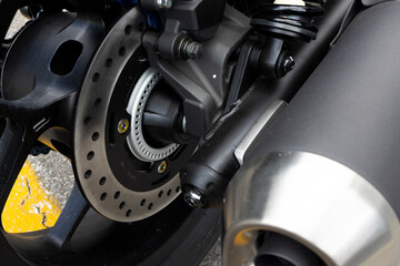 close-up steel of disc brake of motorcycle. sport bike. bigbike. soft-focus and over light in the background