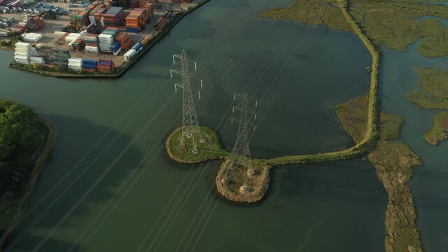 Bird's Eye View On Pylons Over The Test River In Eling, Southampton, England, UK - aerial drone shot
