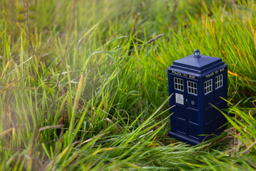 Police public call box on green grass. Blue police box from London as Doctor Who Tardis. Time and...